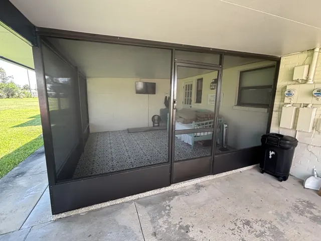 Finished covered enclosure with screened wall, door and solid lower kick plates